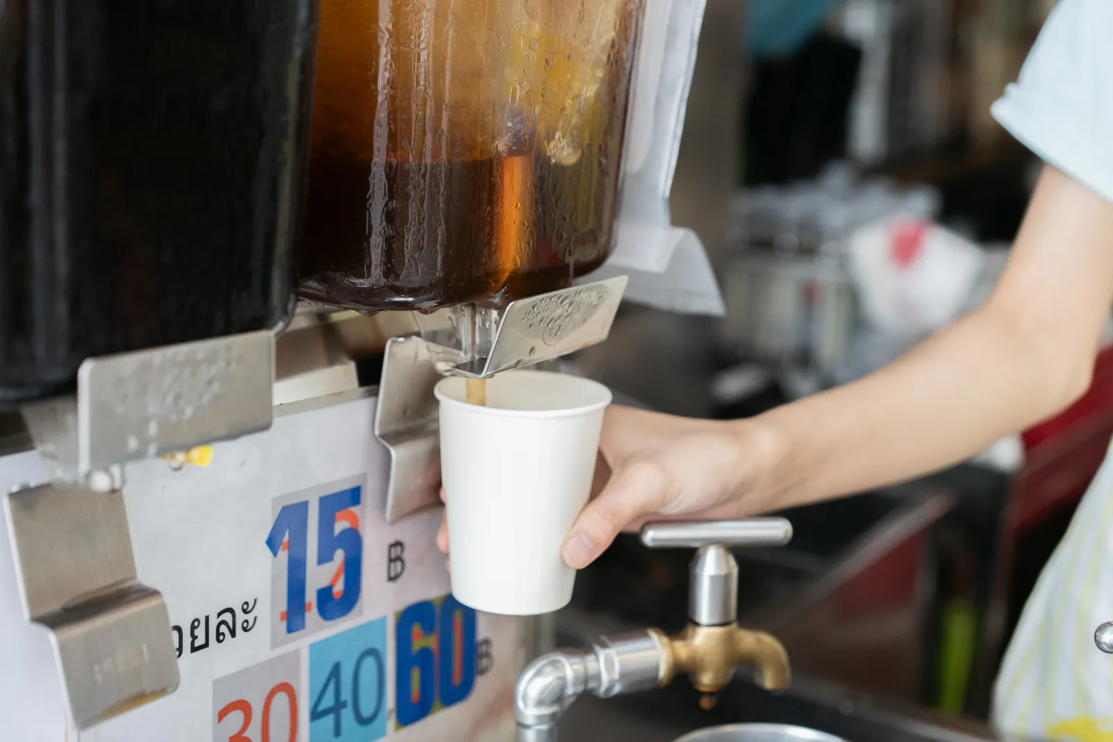 Chinese herb drink poured from an old-school faucet